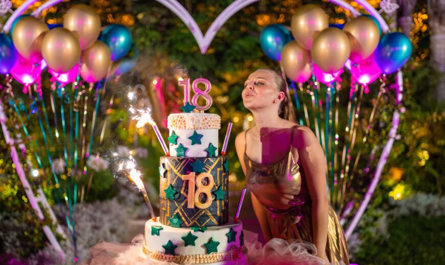 birthday woman blowing candles on cake during celebration